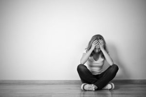 bigstock-girl-sits-in-a-depression-on-t-52227706-700x484